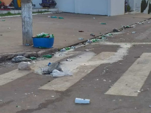 Jovens emporcalham o centro de Juara com garrafas de bebida e sacos plásticos.